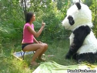 Adult film in the woods with a huge toy panda